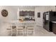 Kitchen with island, granite countertops, and dark cabinets at 24413 W Raymond St, Buckeye, AZ 85326