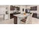 Kitchen with granite island, dark cabinets, and stainless steel appliances at 24413 W Raymond St, Buckeye, AZ 85326