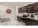 Kitchen with granite countertops, dark cabinets, and stainless steel appliances at 24413 W Raymond St, Buckeye, AZ 85326