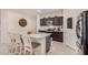 Kitchen with island, granite countertops, dark cabinets, and stainless appliances at 24413 W Raymond St, Buckeye, AZ 85326