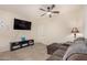 Cozy living room featuring a large TV and comfortable couch at 24413 W Raymond St, Buckeye, AZ 85326