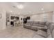Open living space with gray sectional sofa and kitchen view at 24413 W Raymond St, Buckeye, AZ 85326