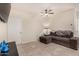 Spacious living room with tiled floors and a large sectional sofa at 24413 W Raymond St, Buckeye, AZ 85326