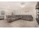 Living room with gray sectional sofa and entertainment center at 24413 W Raymond St, Buckeye, AZ 85326