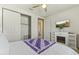Bright bedroom with ceiling fan, sliding door closet, and mounted television at 27395 W Wahalla Ln, Buckeye, AZ 85396