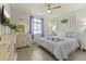 Cozy bedroom with soft natural light, a ceiling fan, and calming decor at 27395 W Wahalla Ln, Buckeye, AZ 85396