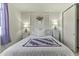 Comfortable bedroom featuring a decorative quilt, lamps and wall decor at 27395 W Wahalla Ln, Buckeye, AZ 85396