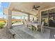 Stylish covered patio with ceiling fan and dining set, perfect for outdoor entertaining at 27395 W Wahalla Ln, Buckeye, AZ 85396