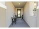 Inviting entrance featuring a cozy seating area and a decorative glass front door at 27395 W Wahalla Ln, Buckeye, AZ 85396