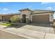 Stunning single-story home featuring a tile roof, a two-car garage, and desert landscaping at 27395 W Wahalla Ln, Buckeye, AZ 85396