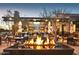 Inviting outdoor fire pit and bar setting, perfect for entertaining guests and relaxing under the stars at 27395 W Wahalla Ln, Buckeye, AZ 85396