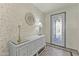Elegant foyer showcasing a decorative mirror and a stylish console table at 27395 W Wahalla Ln, Buckeye, AZ 85396