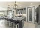 Modern kitchen with granite countertops, stainless steel appliances, and a large island at 27395 W Wahalla Ln, Buckeye, AZ 85396
