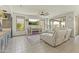 Bright living room featuring a fireplace, neutral finishes, and large windows at 27395 W Wahalla Ln, Buckeye, AZ 85396