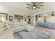 Spacious open concept living room featuring recessed lighting, ceiling fan, and modern finishes at 27395 W Wahalla Ln, Buckeye, AZ 85396