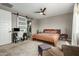 Bedroom with carpet, ceiling fan and sliding barn door to bathroom at 2856 N Riverdale N Ln, Casa Grande, AZ 85122