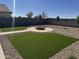 Artificial turf backyard with fire pit and pathway at 28756 N Desert Hills Dr, San Tan Valley, AZ 85143
