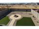 Backyard view with artificial turf, fire pit, and mountain views at 28756 N Desert Hills Dr, San Tan Valley, AZ 85143
