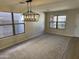 Bright dining room with chandelier, hardwood floors, and large windows at 28756 N Desert Hills Dr, San Tan Valley, AZ 85143