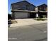 Two-story house with gray exterior, white garage door, and landscaped yard at 28756 N Desert Hills Dr, San Tan Valley, AZ 85143