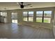 Spacious Gathering room with hardwood floors, ceiling fan, and view of backyard at 28756 N Desert Hills Dr, San Tan Valley, AZ 85143