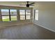 Spacious Gathering room with hardwood floors, ceiling fan, and view of backyard at 28756 N Desert Hills Dr, San Tan Valley, AZ 85143