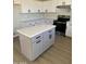 Kitchen island with gray cabinets and quartz countertop at 28756 N Desert Hills Dr, San Tan Valley, AZ 85143