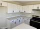 Modern kitchen with white shaker cabinets, quartz countertops, and stainless steel appliances at 28756 N Desert Hills Dr, San Tan Valley, AZ 85143