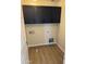 Laundry room with dark cabinets and wood-look flooring at 28756 N Desert Hills Dr, San Tan Valley, AZ 85143