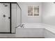 Bathroom with soaking tub, shower, and window at 2989 N 44Th St # 1004, Phoenix, AZ 85018
