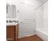 Clean bathroom with a tub, wood floor, and updated vanity at 2989 N 44Th St # 1004, Phoenix, AZ 85018