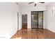 Bedroom with sliding glass door to patio and hardwood floors at 2989 N 44Th St # 1004, Phoenix, AZ 85018