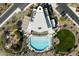 Birds eye view of a community clubhouse that features a pool, playground, parking and well manicured green spaces at 32034 N 125Th Ave, Peoria, AZ 85383