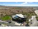 Aerial view of a community clubhouse that features a pool and well manicured green spaces in a desert landscape at 32034 N 125Th Ave, Peoria, AZ 85383