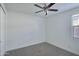 Empty bedroom with carpet, ceiling fan and closet at 32034 N 125Th Ave, Peoria, AZ 85383
