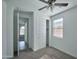 Bright bedroom with ceiling fan, closet, and natural light from window at 32034 N 125Th Ave, Peoria, AZ 85383