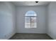 This empty bedroom features a large window and neutral carpet at 32034 N 125Th Ave, Peoria, AZ 85383