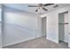 Spacious bedroom with neutral carpet and natural lighting from the window at 32034 N 125Th Ave, Peoria, AZ 85383