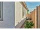 Side exterior of the home featuring an AC unit, stucco siding, and a block wall at 32034 N 125Th Ave, Peoria, AZ 85383