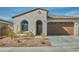 Charming single-story home featuring a tile roof, arched entry, and low-maintenance landscaping at 32034 N 125Th Ave, Peoria, AZ 85383