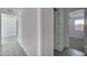 Open hallway with tile floors leads to rooms with ample natural light at 32034 N 125Th Ave, Peoria, AZ 85383