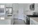 Contemporary kitchen with stainless steel appliances, white cabinetry, and a functional center island at 32034 N 125Th Ave, Peoria, AZ 85383