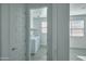 View of the laundry room with white appliances, floating shelves, and a view of the home's interior at 32034 N 125Th Ave, Peoria, AZ 85383