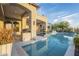 Luxury pool and spa with outdoor fireplace and seating at 3330 S Sycamore Village Dr, Gold Canyon, AZ 85118