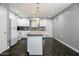Modern kitchen with granite countertops and dark wood floors at 3331 W Del Monico Ln, Phoenix, AZ 85051