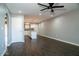 Open living room with dark wood-look floors and a view of the kitchen at 3331 W Del Monico Ln, Phoenix, AZ 85051