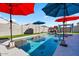 Stunning pool area with multiple umbrellas providing shade and a fun atmosphere at 38100 W Santa Clara Ave, Maricopa, AZ 85138