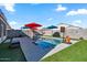 Refreshing pool surrounded by artificial turf and colorful umbrellas at 38100 W Santa Clara Ave, Maricopa, AZ 85138