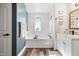 Spa-like bathroom featuring a soaking tub, vanity, and window at 38100 W Santa Clara Ave, Maricopa, AZ 85138