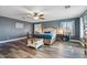 Main bedroom with wood-look floors and ceiling fan at 38100 W Santa Clara Ave, Maricopa, AZ 85138